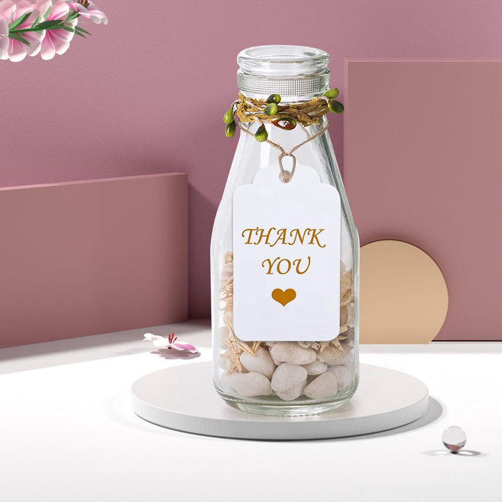 Decoratieve fles met Thank You label en jute touw, ideaal voor bedankjes en geschenken.